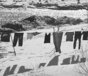 clothes on washing-line and shadows against snowy landscape